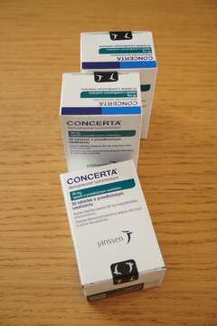 Three boxes of Concerta medication arranged on a wooden table, displaying packaging details and company logos.