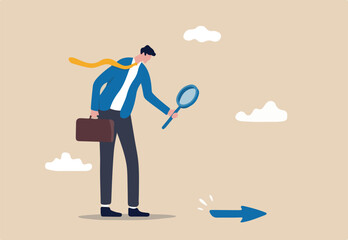 Searching for business direction, strategy or discover business opportunity or solution for work difficulty concept, businessman leader using magnifying glass to discover arrow on the floor