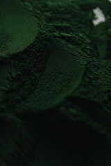 Spirulina powder close up, green superfood, organic healthy supplement