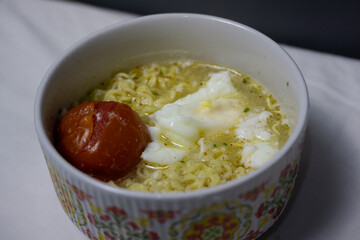 A Comforting Bowl of Homemade Instant Noodle Soup with Egg and Tomato