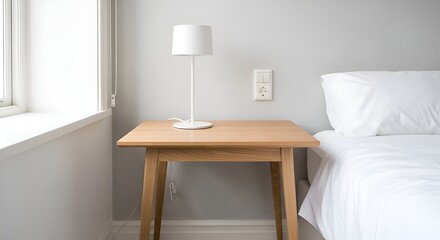 A modern Scandinavian table with a white lamp, placed neatly in a bright bedroom