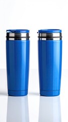 Two vibrant blue, stainless steel travel mugs with secure lids, positioned side-by-side against a stark white background, reflecting subtly