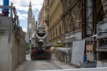 Historic Vienna Street Under Construction with Cement Mixer and Stunning Architectural Backdrop