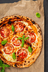 Pizza tomato margarita fast food natural product tasty snack fresh delicious gourmet food background on the table rustic top view copy space