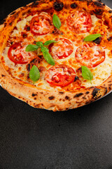 Pizza tomato margarita fast food natural product tasty snack fresh delicious gourmet food background on the table rustic top view copy space