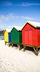 Naklejka premium Colorful beach huts on a sandy shore (1)