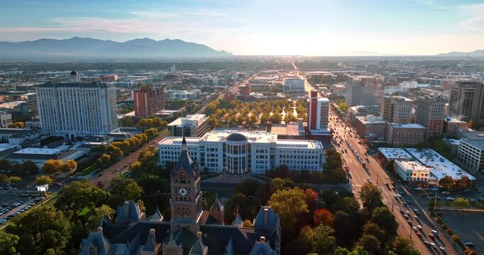 Approaching Salt Lake City and County Building and the Building of Court. Drone flight above the city at sunset.
