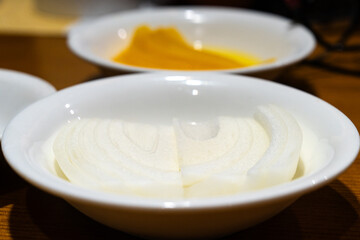 white onion against pickled radish at the Chinese restaurant