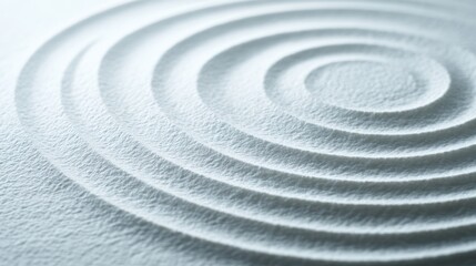 A calming concentric circle pattern in pale, fine-grained sand forms a zen garden