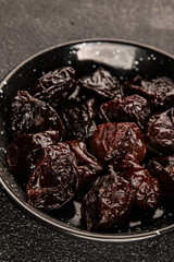 Prunes smoked plum portion size natural product tasty snack fresh delicious gourmet food background on the table rustic top view copy space keto and paleo diet vegetarian and vegan food