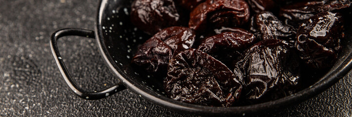 Prunes smoked plum portion size natural product tasty snack fresh delicious gourmet food background on the table rustic top view copy space keto and paleo diet vegetarian and vegan food