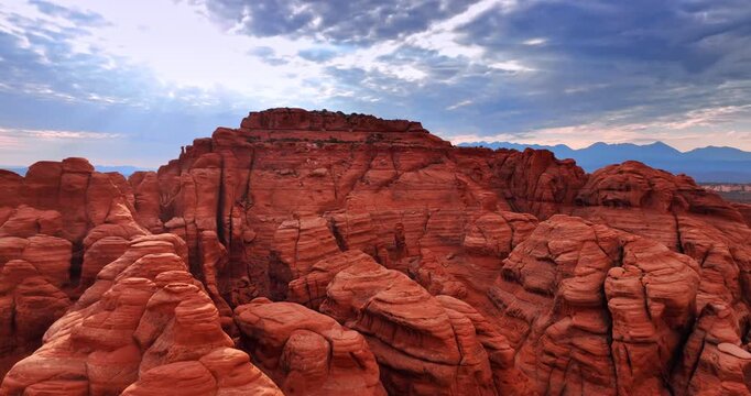 Approaching the top of the red canyon rounded by the power of wind. Drone footage above the Arches National Park, Utah, USA.