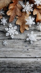 Minimalist vertical image of snowflake clusters and dry leaves on raw wooden planks, no text or logo