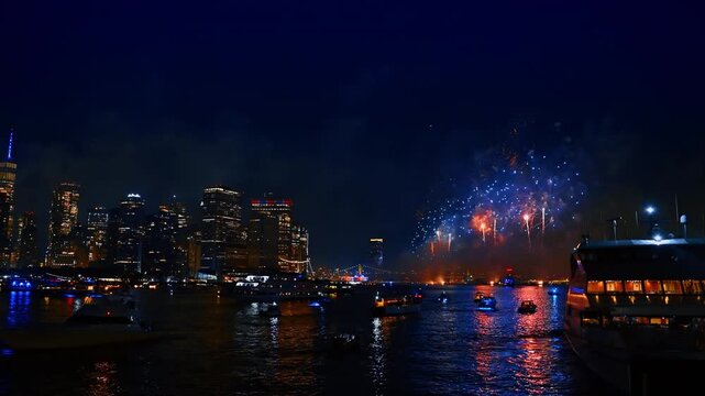 Firework celebration in New York, USA. 4th July festival over the East River. Numerous boats watch the show.