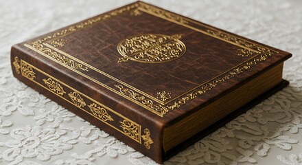 Fototapeta premium An exquisitely crafted brown leather book with elaborate gold embellishments on the cover and spine, showcasing gilded page edges