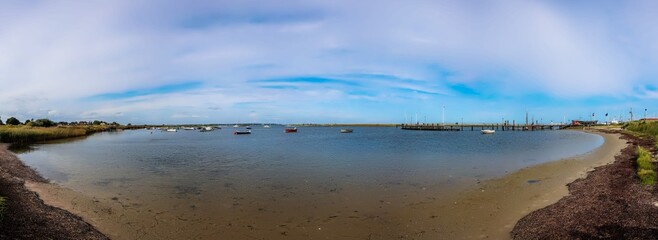 Panoramic harbor view with moored boats and pier © Michael