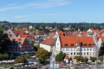 Panoramic cityscape of the historic old town of Lindau, Bavaria, Germany. Aerial view of traditional buildings, church towers, and red rooftops on a sunny summer day