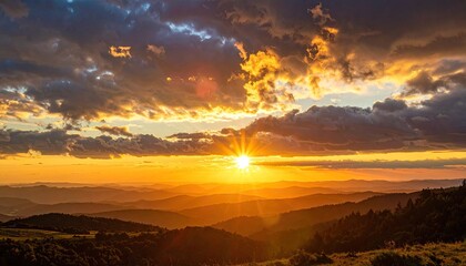 Dramatic Sunset Over Lush Green Mountain Range with Golden Light and Cloudy Sky in Outdoor Scenery