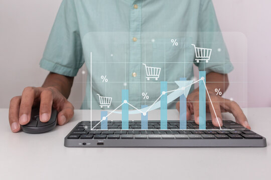 E commerce sales growth concept. Man typing on keyboard with virtual graph. Rising online shopping trend.