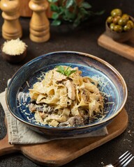Delicious creamy pasta served with mushrooms and cheese in a rustic kitchen setting, ideal for a cozy meal