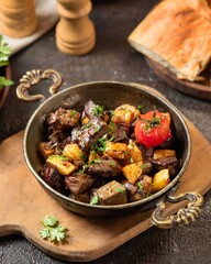 Savory mixed meat stew with potatoes and herbs served in a bowl, perfect for a hearty lunch or dinner