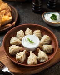 Delicious dumplings served with yogurt in a rustic setting perfect for an enjoyable meal experience
