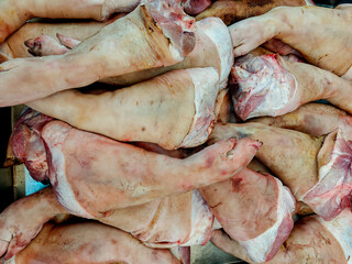 Fresh Raw Pork Legs on cool Tray at Local Market