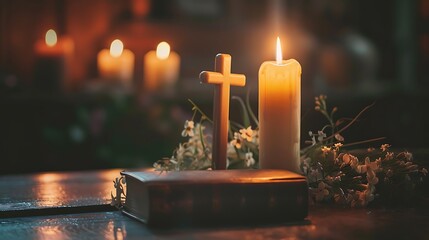 Wooden cross candle and book with blurred lights