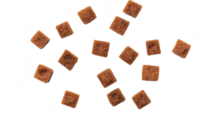 A scattered arrangement of brown sugar cubes on a clean white background. their texture and color. ideal for culinary. food styling. or product photography uses