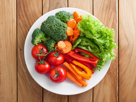 Fresh assorted vegetables on a white plate, healthy food and nutrition concept