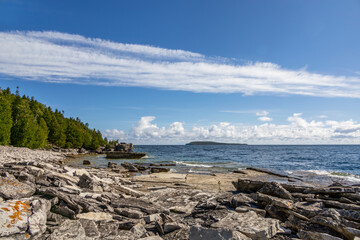 A stunning view of Flowerpot Island's rugged coastline in Georgian Bay, Ontario, showcasing its unique limestone formations and serene natural beauty.