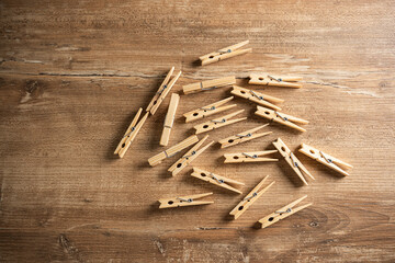Wooden clothespins scattered on a rustic wooden table creating a natural and cozy atmosphere for household activities