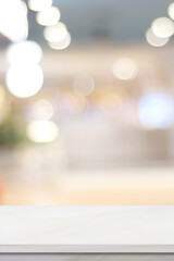 Empty vertical white table top, counter, desk background over blur  bokeh background, White marble stone table, shelf and blurred kitchen restaurant for food, product display mockup, template