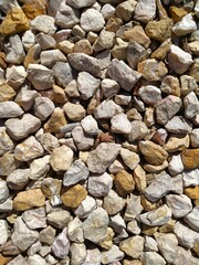 Texture image, yellowish-white, with a surface of smaller limestone fragments, for background, base, wallpaper.