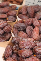 Closeup of large dates on a market stall, fresh dried fruit, healthy food