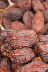 Closeup of large dates on a market stall, fresh dried fruit, healthy food