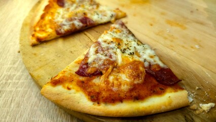 Delicious slices of pepperoni pizza served on a wooden board
