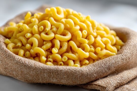 Pasta fills burlap sack showcasing elbow macaronis yellow color  unique curved shape