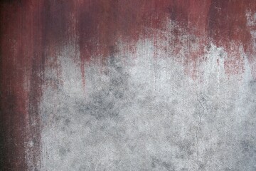 Grungy concrete wall with red paint streaks grunge
