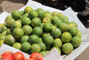 Sweet limes are piled up at the fruit market for sale.