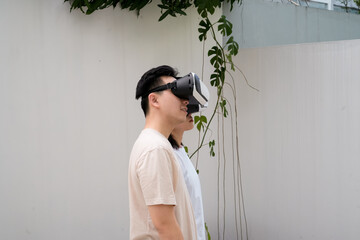 couples wear VR headsets in a sunny urban backyard, exploring immersive visuals together