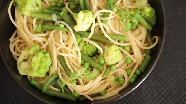 Spaghetti vegetables green peas, broccoli, string beans, kohlrabi vegetarian pasta tasty snack fresh delicious gourmet food background on the table rustic top view copy space vegan food