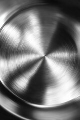 Close-up of brushed stainless steel pot interior with circular texture and clean reflective surface