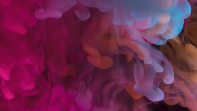 Watch as colorful inks blend and move dynamically in a dark setting, creating mesmerizing patterns and textures full of life and energy