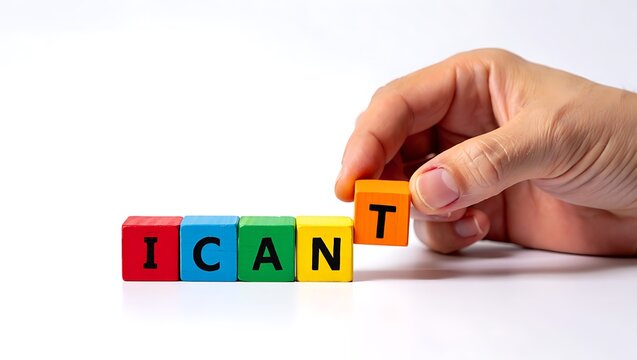 Hand placing colorful letter cubes forming the word 'icant' in a creative concept