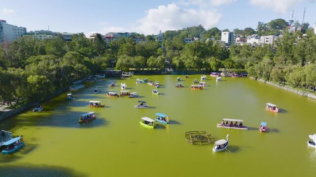 Aerial View of Burnham Park and Lake in Baguio, Philippines
the bustling Burnham Lake, where families, couples, and friends enjoy a variety of rental boats, including the iconic swan boats