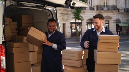 Two delivery workers are unloading boxes from a van on a bustling city street. They smile as they carefully handle packages, showcasing an active delivery scene