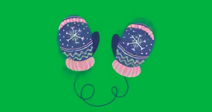 Pair of winter mittens floating on transparent background, showing snowflake motif and yarn loops