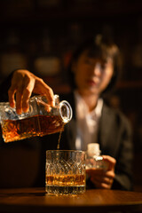 Closeup business woman holding a glass of whiskey