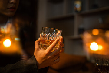 Closeup business woman holding a glass of whiskey
